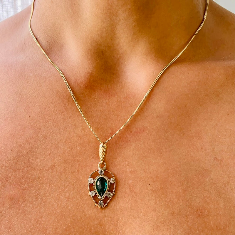 Gold necklace with a green pendant on model | Deheb Jewellery Malta