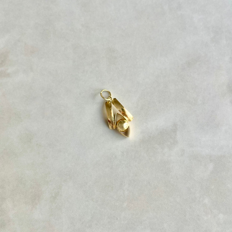 Gold pendant on a light grey background | Deheb Malta Jewellery