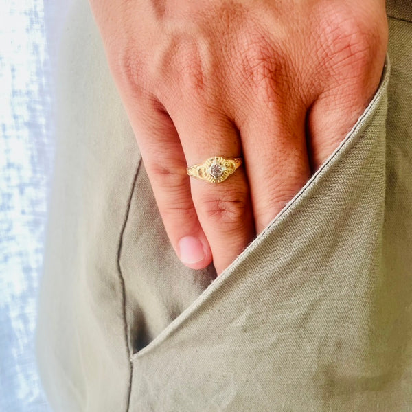 Hand wearing a gold ring with a diamond | Deheb Jewellery Malta