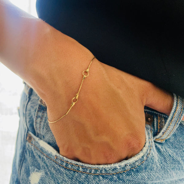 Gold bracelet on a wrist with a blurred background | Deheb Jewellery Malta