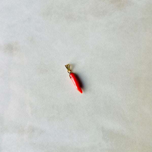 Red chilli pepper-shaped pendant on a gold chain against a light gray background | Deheb Malta Jewellery