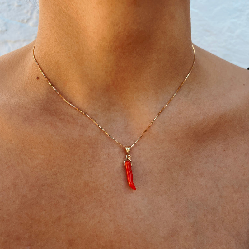 Coral chilli pendant worn on model 