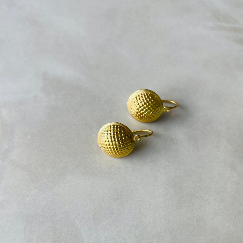 Pair of gold textured ball earrings on a light gray background | Deheb Malta Jewellery