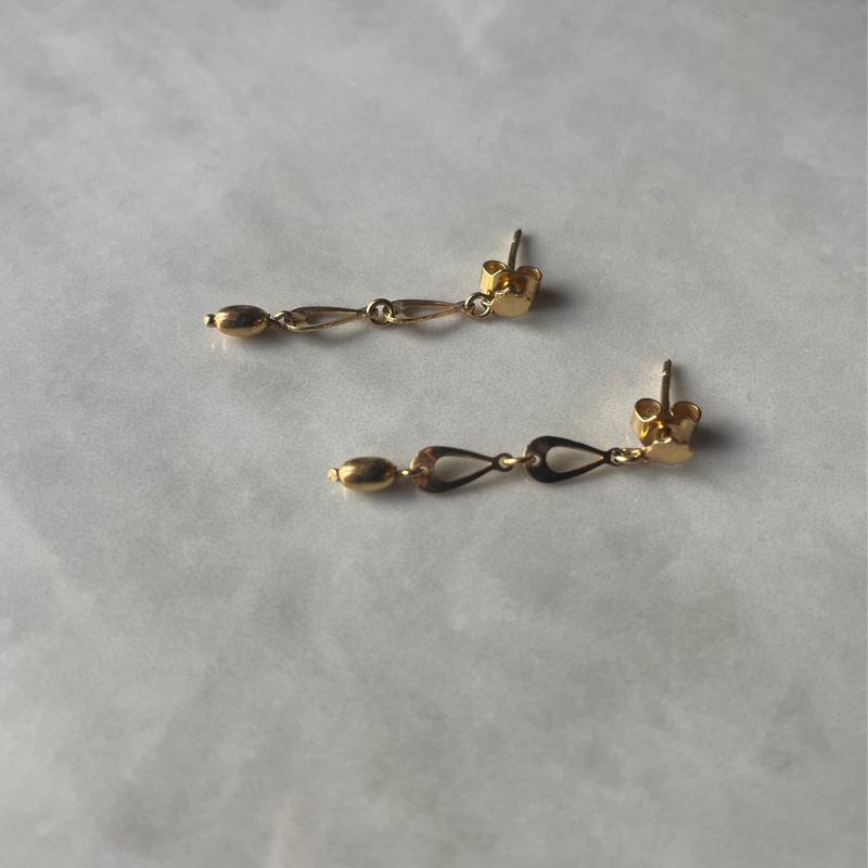 Drop earrings shot on surface