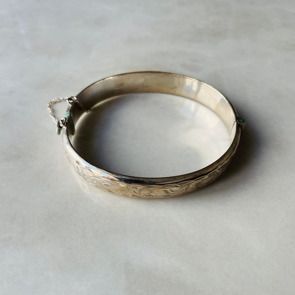 Silver bracelet with intricate designs on a light gray background | Deheb Jewellery Malta