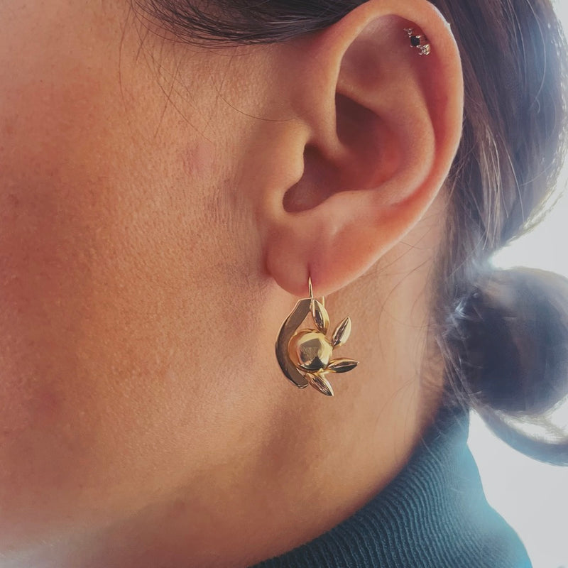 Eye earring worn on model