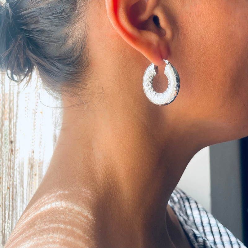 Silver flat hoop earrings worn by model