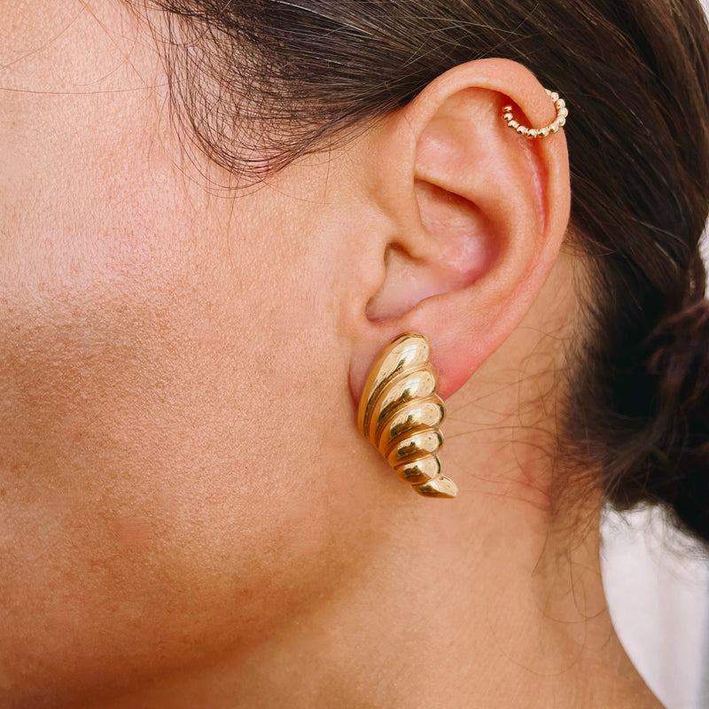 Oversized gold earrings jewellery on model