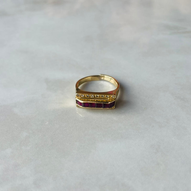 Gold ring with diamonds and rubies on a light gray background | Deheb Jewellery Malta
