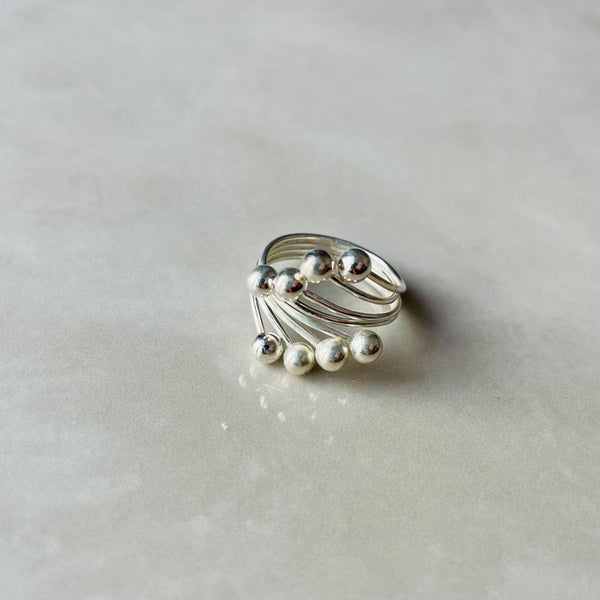 Silver spiral wide on grey surface | Deheb Malta Jewellery