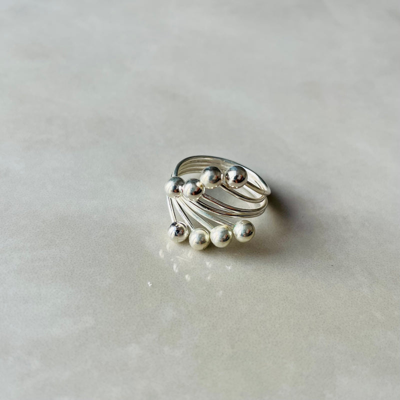 Silver spiral wide on grey surface | Deheb Malta Jewellery