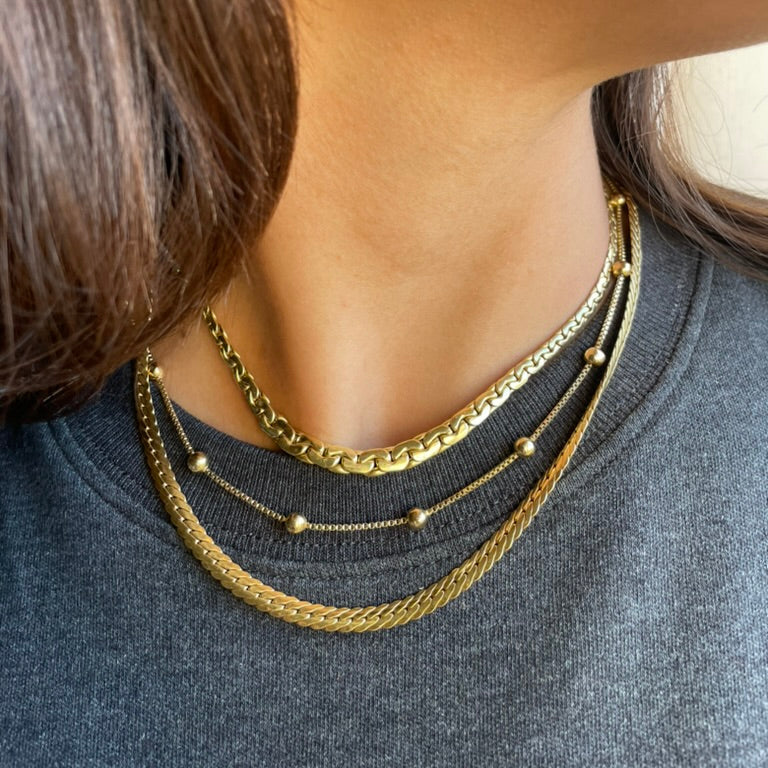 stacked necklaces on model