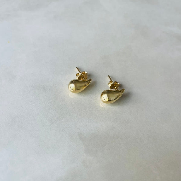 Gold tear drop earrings on a light gray background | Deheb Jewellery Malta