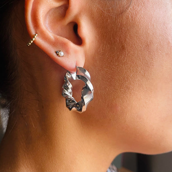 Twist hoop earrings on model